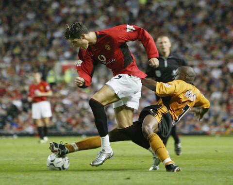 Ronaldo of Man Utd tackled by Newton of Wolves