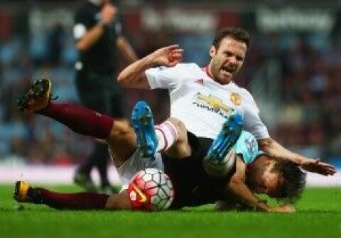 Juan Mata of Manchester United is challenged by Mark Noble of West Ham United during the Barclays Premier League match between West Ham United and Manchester United at the Boleyn Ground on May 10, 2016 in London, England.