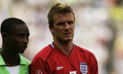 David Beckham of England is marked by Femi Opabunmi of Nigeria