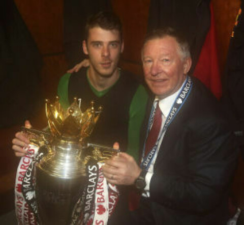 MANCHESTER, ENGLAND - MAY 12: David de Gea and Manager Sir Alex Ferguson of Manchester United celebrate with the Barclays Premier League trophy in the dressing room after the Barclays Premier League match between Manchester United and Swansea at Old Trafford on May 12, 2013 in Manchester, England. (Photo by John Peters/Man Utd via Getty Images)