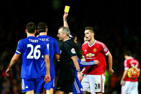 MANCHESTER, ENGLAND - DECEMBER 28: Morgan Schneiderlin of Manchester United receives a yellow card from referee Martin Atkinson for a foul on Willian of Chelsea during the Barclays Premier League match between Manchester United and Chelsea at Old Trafford on December 28, 2015 in Manchester, England. (Photo by Clive Mason/Getty Images)
